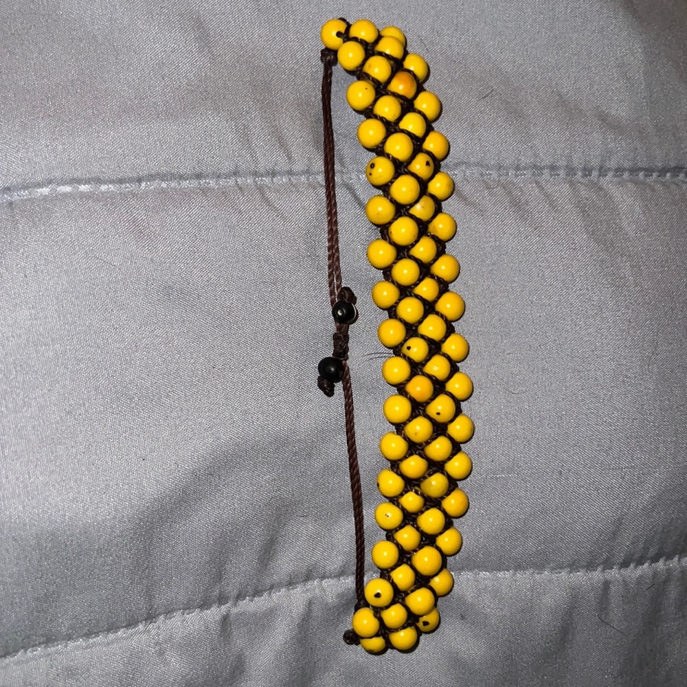 Yellow adjustable anklet or bracelet.